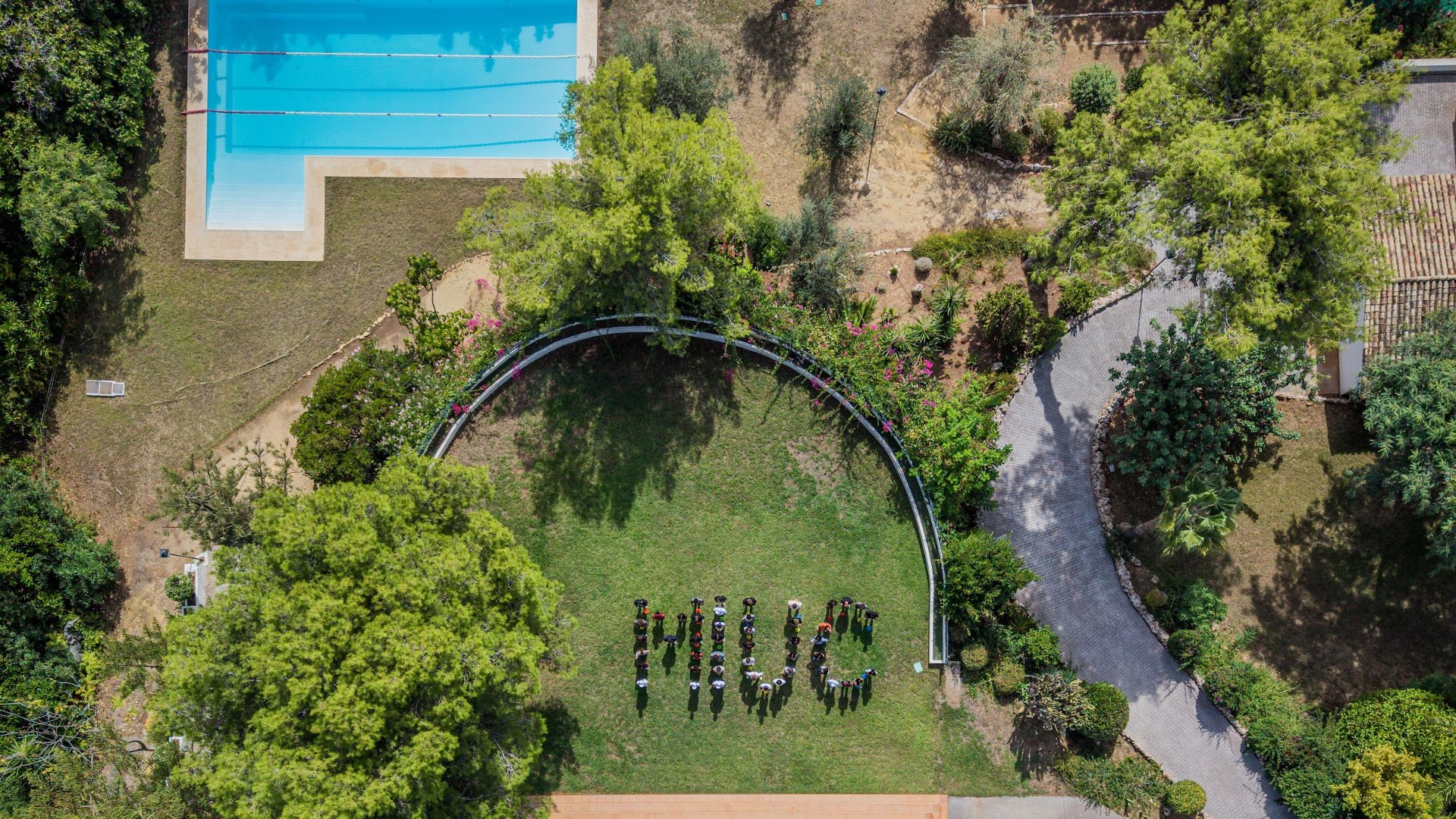 Aerial view of the MIUC campus in Marbella with students spelling MIUC on the lawn